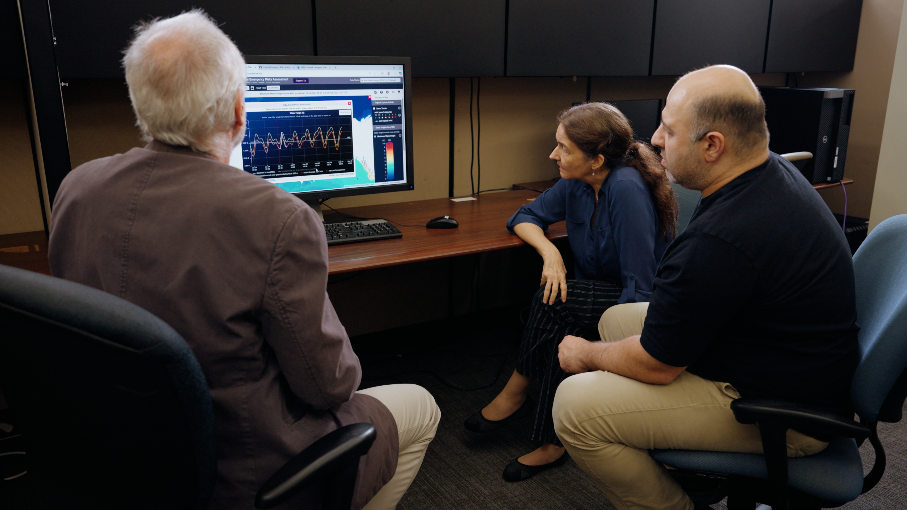 CERA researchers looking at data on screen