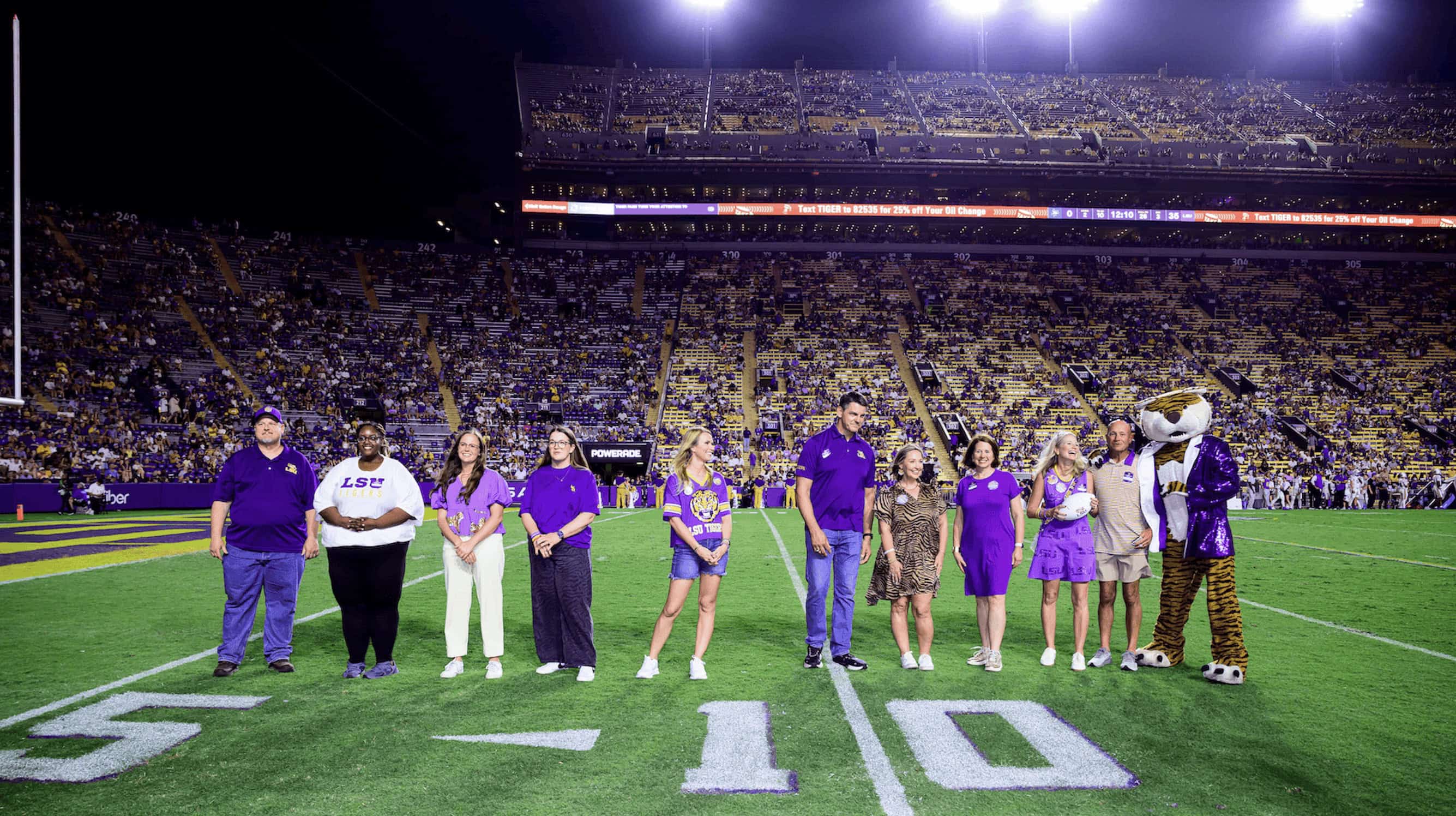 2027 Louisiana Teachers and principals of the year stand on the field in Tiger stadium